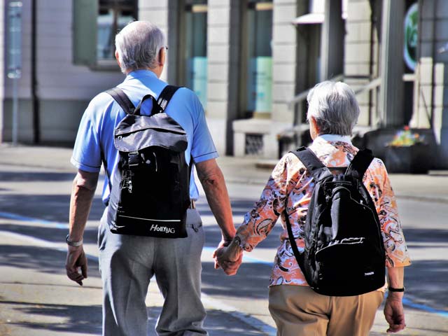 Image of old couple holding hands